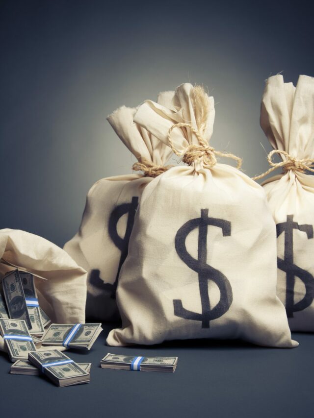 White bags with dollar signs on them filled with money