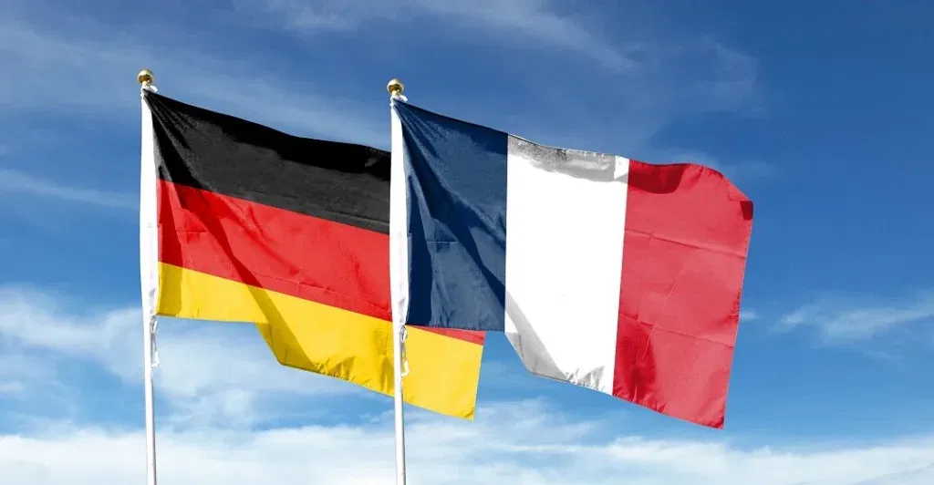 Flags,of,france,flag,and,germany,flag,against,cloudy,sky.